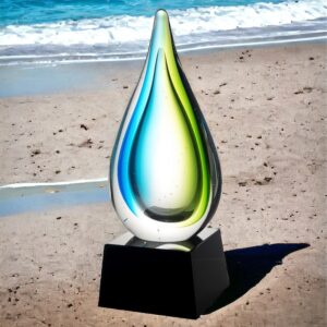 Our Tropic Drop Art Glass Award. It features a glass raindrop with tropical blue & green colors on the sides. It's mounted on a black glass base that includes a black & silver engraving plate for personalization. It stands 9" tall & weighs 4 lbs.