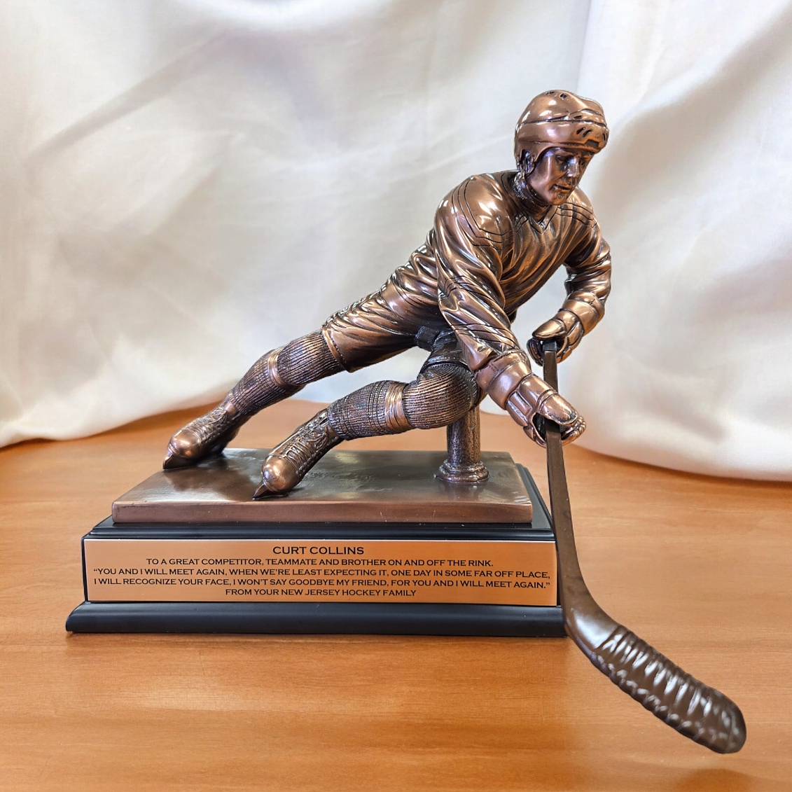 Hockey Trophy RFB023 features a resin statue coated with a bronze metal for added detail & strength. The hockey player is in full uniform with his stick in hand. It's mounted on a black base that includes a matching bronze plate that is personalized. It's 12" x 10" in size & weighs over 8 lbs.