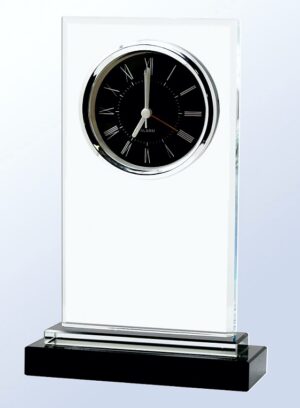 Our Rectangle Glass Clock features a vertical clear glass rectangle with a black face clock with silver roman numerals & bezel. Below the clock is a blank area for laser engraving. It's all mounted on a 2 tier black glass base. This ZG2421 clock is 6" x 9" in size & weighs 3.2 lbs.