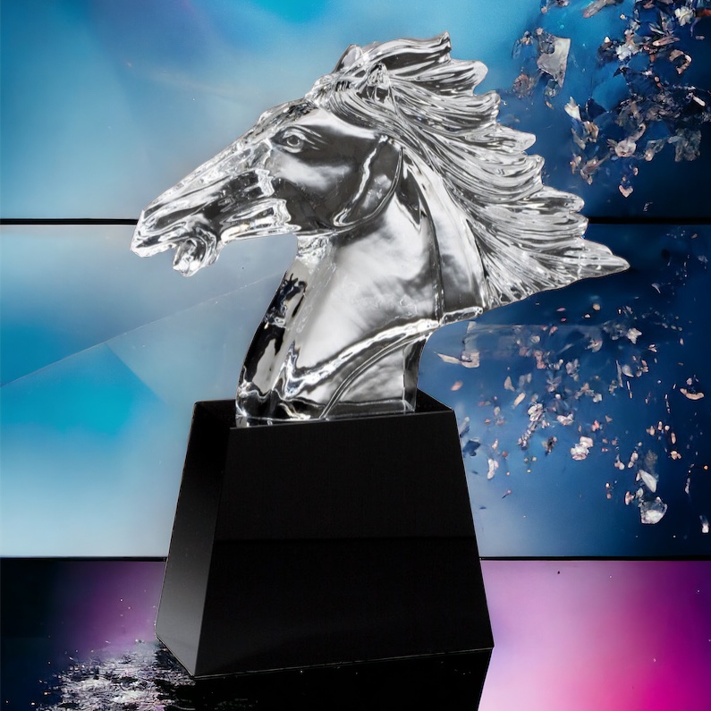 Our Large Crystal Horse Head features a detailed clear crystal horse head on a black crystal base. The base includes an engraving plate for personalization. This CRY300 horse head is 12.5" tall, weighs over 6 lbs. and includes both free engraving & free shipping. This particular award is sitting on a black table with a pink reflection on the table and dynamic blue colors in the background.