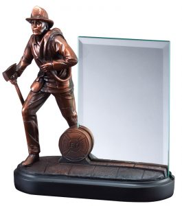 This is a firefighter statue with a glass engraving plate. It features a bronze firefighter with a hose on his left shoulder, an axe in his right hand & helmet on his head. To his left is a 4" x 6" glass engraving plate that is there to be personalized with laser engraving or full color.