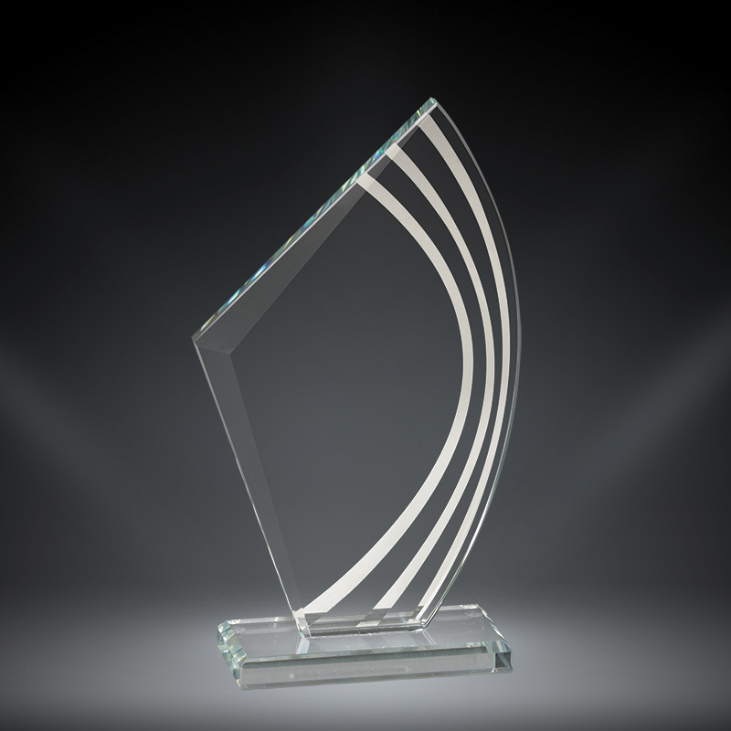 Our Contour Sale Glass Award features a contemporary sail design with contour lines on the right side for added decoration. The left side of the award is for laser engraving personalization. The glass piece is mounted on a clear glass base for added stability.