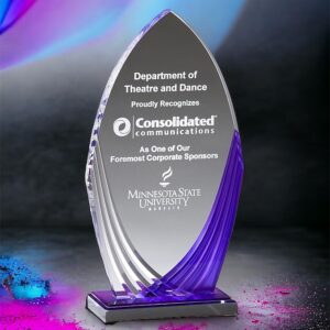 Our Purple Tidal Acrylic Award with a pointed top, purple highlights on the side & a reflective purple mirror base. It's sitting on a black table with dynamic colors all around.