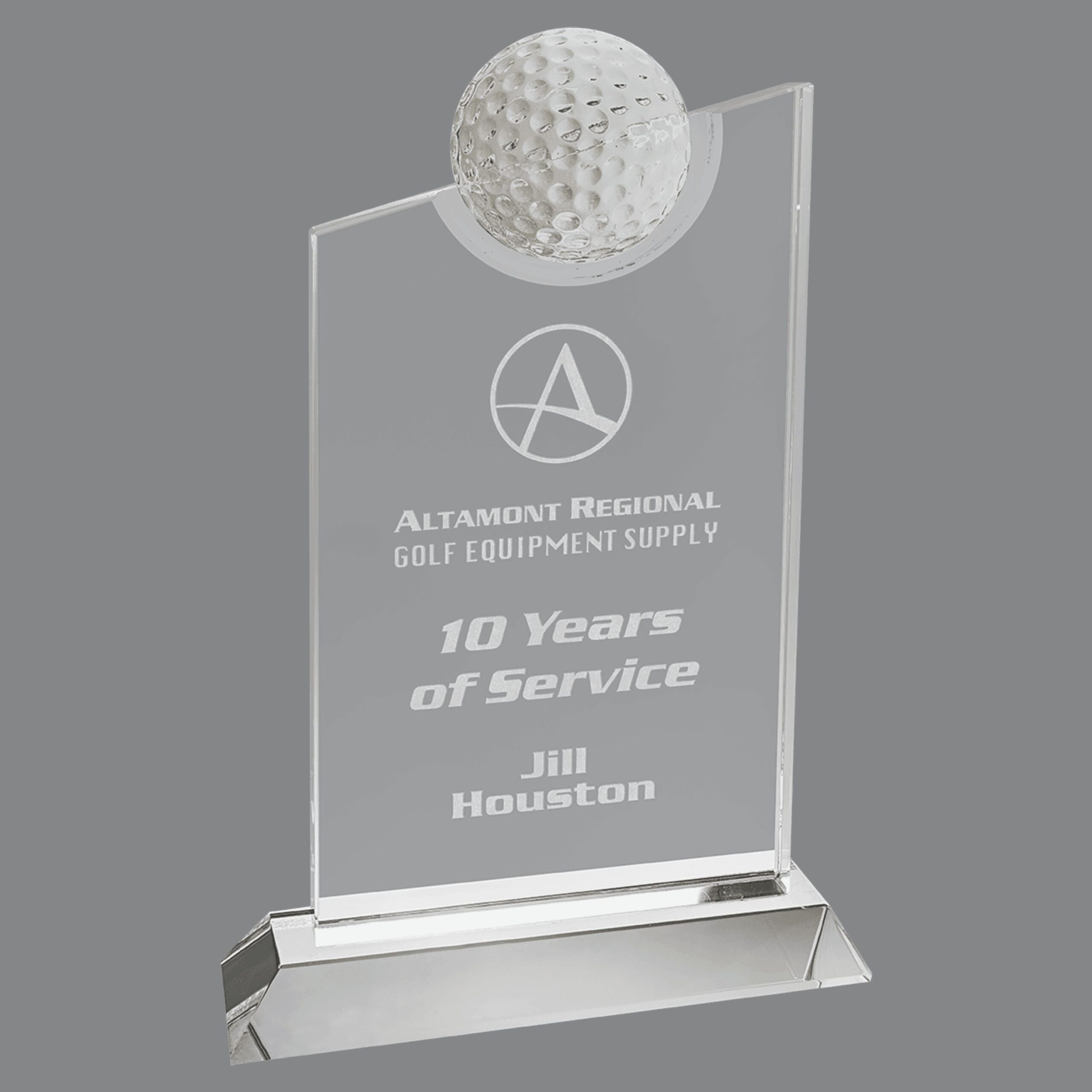Our Slanted Golf Ball Trophy features a piece of crystal with a slant from right to left at the top. Also at the top is a 2.5" in diameter golf ball that is mounted for added golf decoration. Below is the area for engraving. This specific trophy is for Jill Houston who has 10 years of service at the Altamont Regional Golf Equipment Supply.