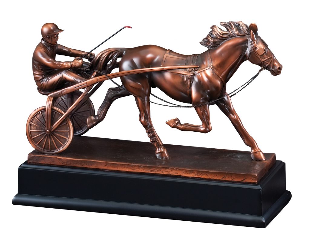 Our Sulky Harness Racing Statue featuring a resin statue that is coated with a thin metal layer for added strength & detail. I shows a race horse pulling a sulky & jockey. The jockey has a helmet on and a whip in hand. It's mounted on a black base that includes a bronze engraving plate for personalization. This RFB031 Sulky Statue is 12.5" long, weighs7.3 lbs and includes both free engraving & free shipping.