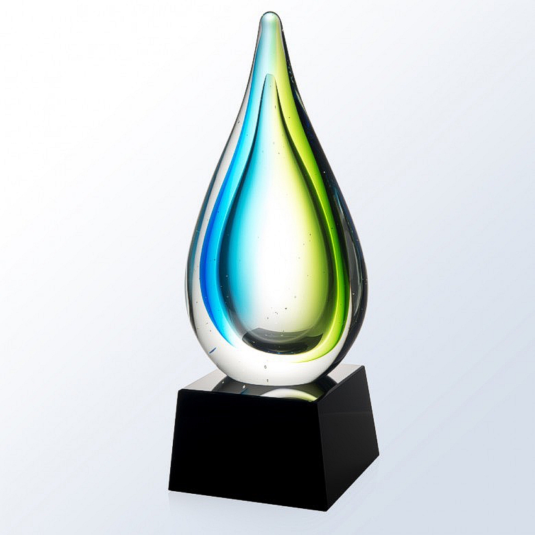 Our Tropic Drop Art Glass Award on a plain white & gray background. It features a glass raindrop with tropical blue & green colors on each side. The raindrop is mounted on a black glass base that can be personalized.