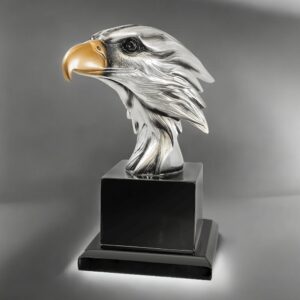 Our Silver Eagle Head on Black Base features a silver eagle head with a gold beak mounted on a wood base. The base includes an engraving plate for personalization, but is not shown in this photo. This EGL79 is 7.25" tall, weighs 2 lbs & includes free engraving.