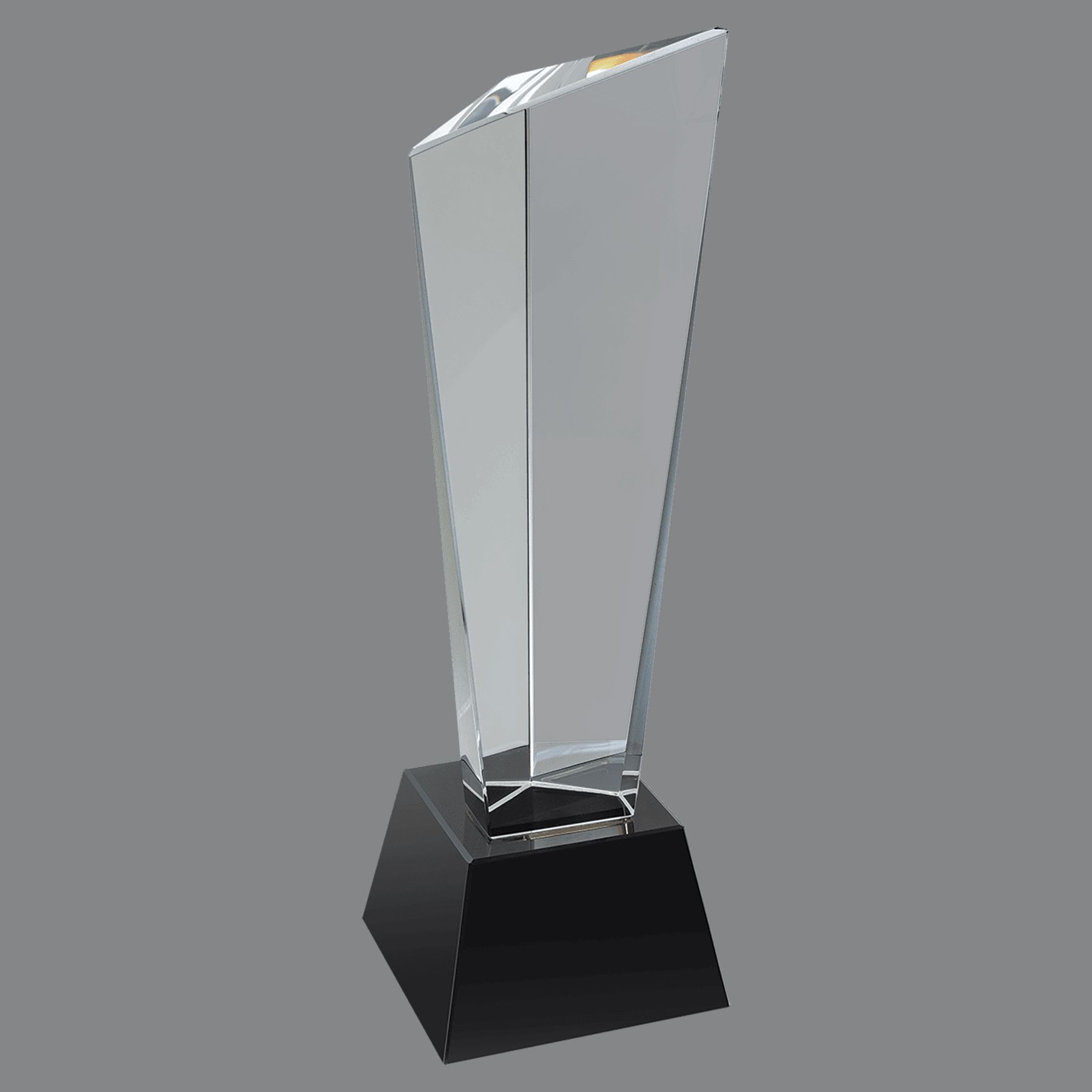 Rising Peak Crystal Award shows a vertical piece of crystal that is smaller at the bottom and getting larger at the top. One of the three corners rises higher than the other two, thus giving it the rising peak effect. The front is blank and is intended for laser engraving personalization. It's mounted on a black crystal base. It measures 3" x 10" in size and weighs 4.3 lbs.