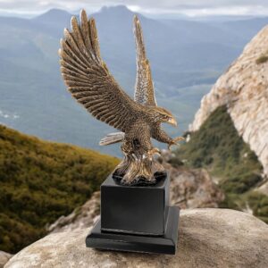 Our Eagle In Flight Statue features an antique gold bald eagle with his wings spread and talons reaching downward in attack. It's mounted on a black wood base that includes an engraving plate for personalization. This EGL80AG is 10.75" tall & weighs over 2 lbs.