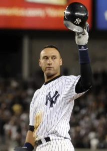 A photo of Derek Jeter in his Yankee's uniform as he raises his helmet to the crowd.